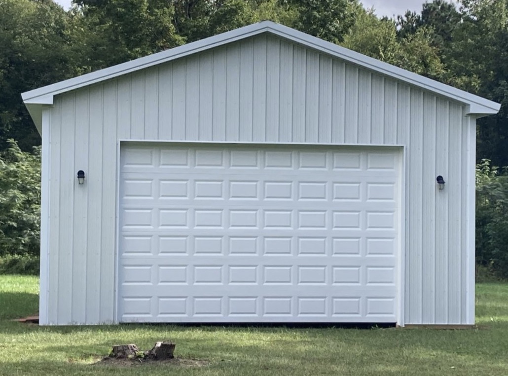 Detached two-car garage with white doors
